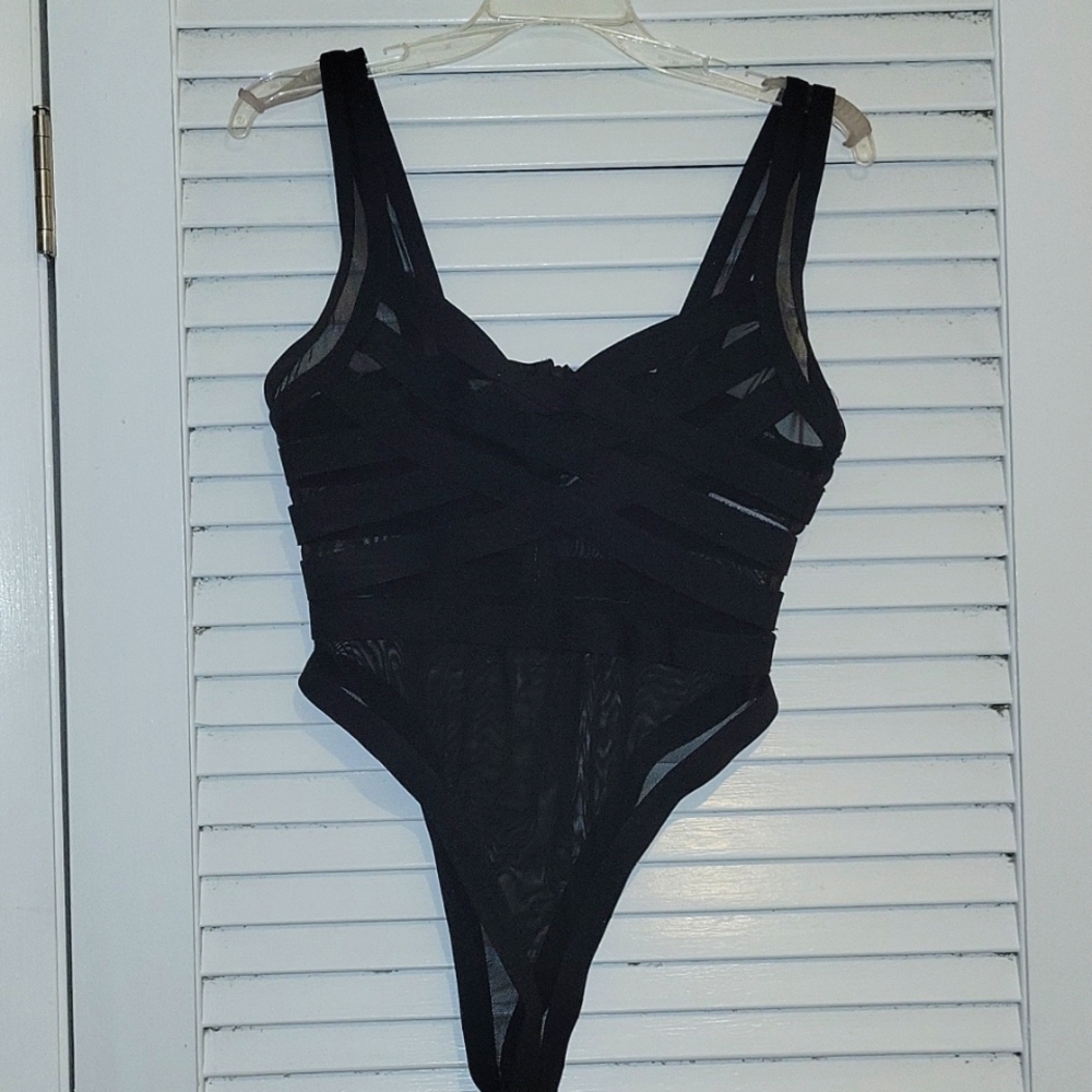 Forever 21 black bandage mesh body suit w zipper closure. Size Large.